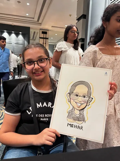 A happy guest with her new caricature, drawn live at an event. The yellow watercolor outline adds a nice pop of color to the portrait.