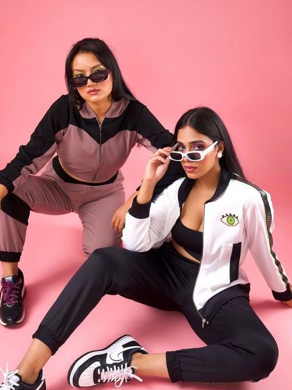 An edgy, sporty look for Raki Designs. The makeup is minimal with a slight winged liner to go with the sunglasses and tracksuits.