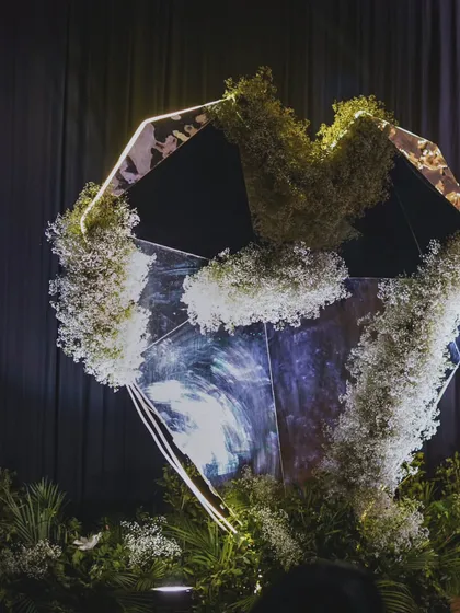 Bespoke artistry is our signature. This custom-designed, diamond-shaped mirrored installation, adorned with delicate baby's breath, served as a unique and glamorous photo point for a chic cocktail event.