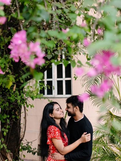 Finding a pocket of nature within the city. I framed this shot through vibrant pink bougainvillea to add a layer of softness and romance to this urban pre-wedding portrait.