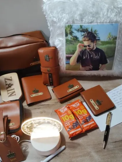 The full gift set for actor Zain Imam, showing the personalized leatherette items alongside a custom photo pillow and other goodies.