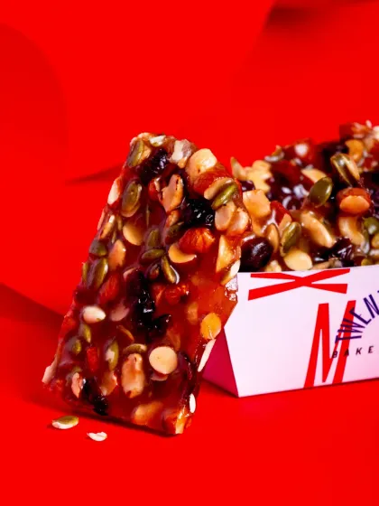 A piece of our Winter Brittle, a perfect bite-sized snack packed with nuts and seeds.