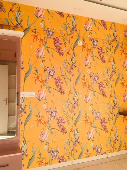 A bold, yellow floral wallpaper makes this room feel sunny and cheerful. The vibrant pattern covers the entire wall, creating an immersive and energetic atmosphere.