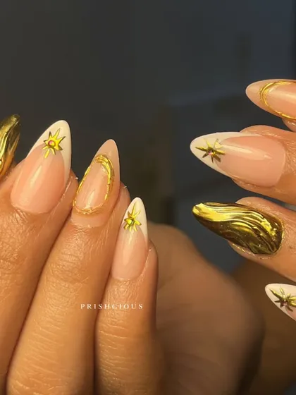 The full celestial chrome set. This design combines a modern white French tip with 3D gold chrome elements like moons, stars, and abstract shapes for a truly magical look.