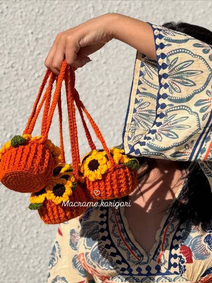 A fun shot showcasing the mini sunflower pot car charms. Their small size and bright colors make them an instant mood-lifter.