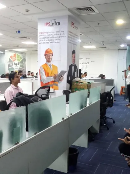 A seated meditation practice being guided in an office environment. We teach simple mindfulness techniques that employees can use throughout their day to manage stress and stay centered.