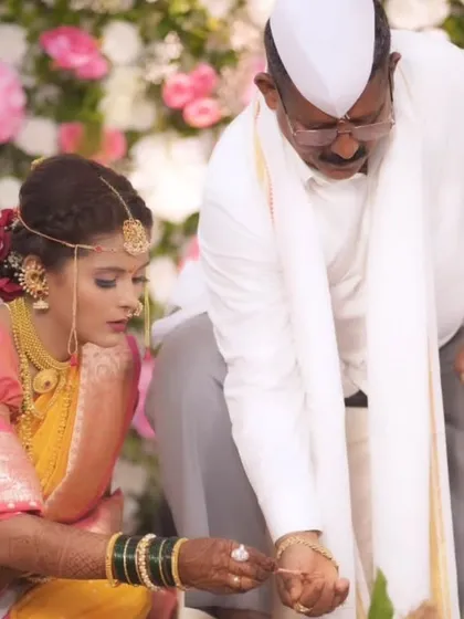 A touching moment during the wedding rituals, with a focus on the bride's serene expression and detailed makeup.