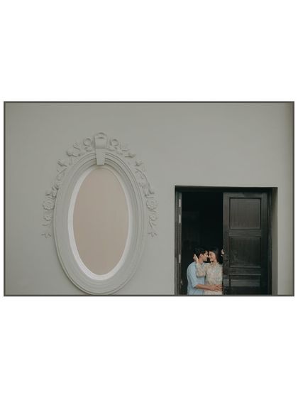 A creative portrait using a window as a natural frame. This shot from Udaipur plays with negative space and composition to create a visually interesting and intimate photograph.