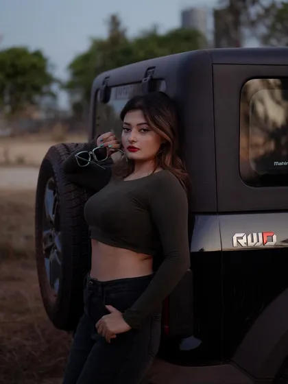 A duplicate of image 333, this portrait of a model with a Thar jeep at dusk has a beautiful, atmospheric quality.