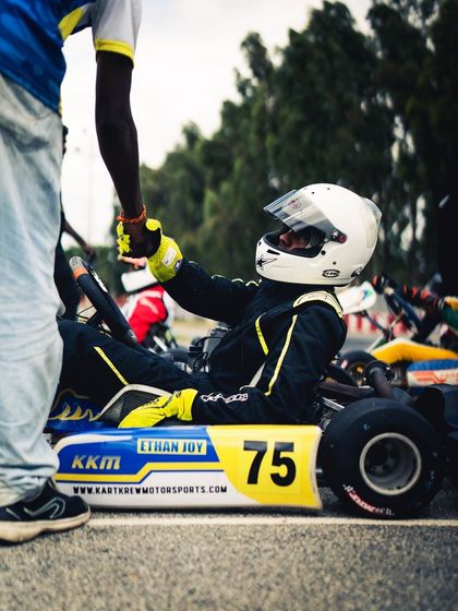 A moment of connection between a driver and his mechanic. This handshake signifies the trust and teamwork needed to overcome challenges and succeed.