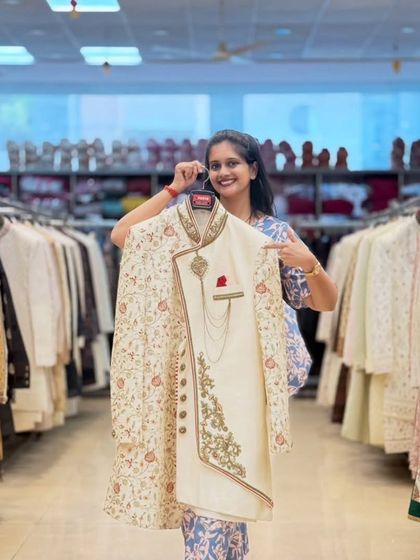 This is the kind of royal look I love providing for grooms. An off-white sherwani with an embroidered jacket layer, complete with a pocket square and chain accessory for that final touch.