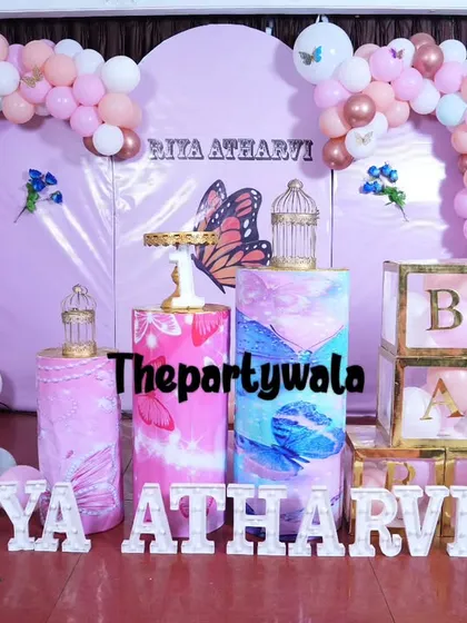 A lovely butterfly theme with a soft pink and rose gold color palette. The setup includes "ONE" display shelves and light-up letters for the name.