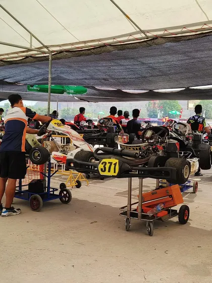 Karts on trolleys in the pit lane, ready for the next session.