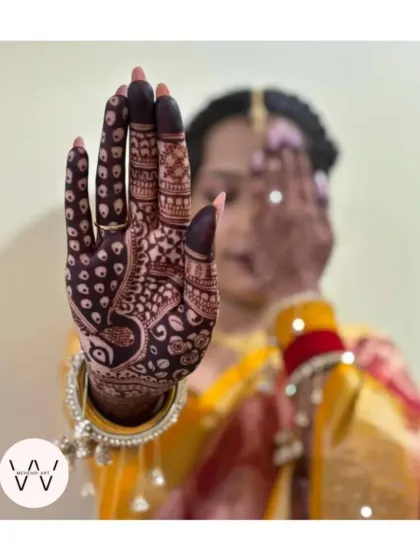 The rich, dark stain of an engagement henna design. The peacock motif is the star of this look, symbolizing grace and beauty.