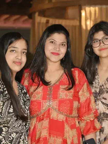 A mother poses with her two lovely daughters. This portrait captures the strong bond and friendship between them.