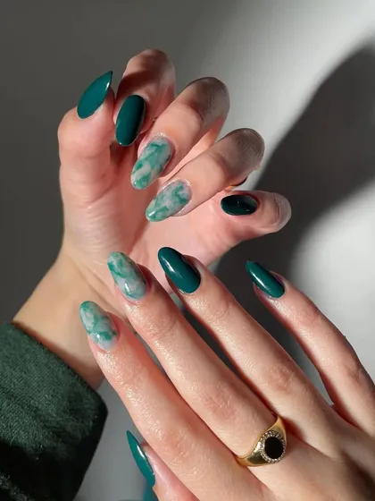 Another angle of the sophisticated emerald and marble nail set. This view shows how the different designs complement each other across the hands for a cohesive, luxurious look.