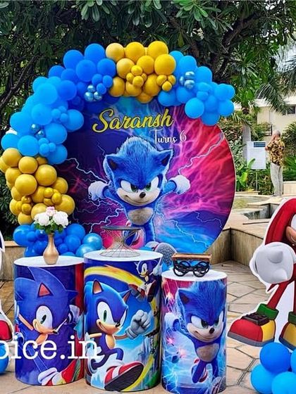 A high-energy Sonic the Hedgehog party by the pool. The decoration features a dynamic backdrop of Sonic, themed pedestals, and character cutouts, all in vibrant shades of blue and yellow.