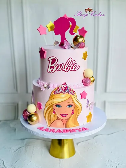 A dreamy Barbie cake fit for a little princess. This two-tier pink cake celebrates in style with sparkle, glam, and lots of sweetness.
