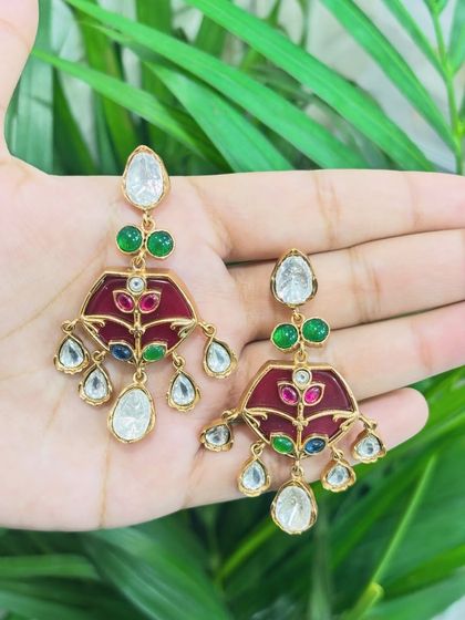 These earrings feature beautiful red enamel work (meenakari) and Polki stones, a colourful rental option for guests.