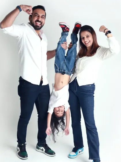 This family knows how to have fun! A playful pose with their daughter held upside down shows their energetic and joyful spirit.
