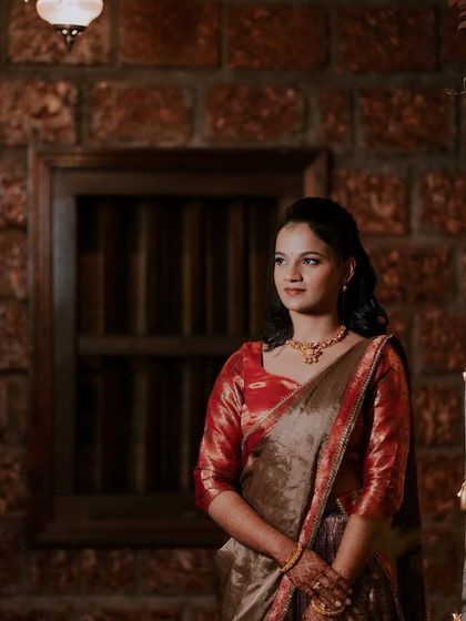 A pensive portrait of the bride. The soft lighting and the rustic background create a beautiful, timeless image.