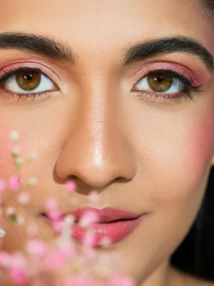 A soft, romantic look featuring pink tones and delicate baby's breath flowers. This is a beautiful idea for a pre-wedding shoot or a whimsical party look.
