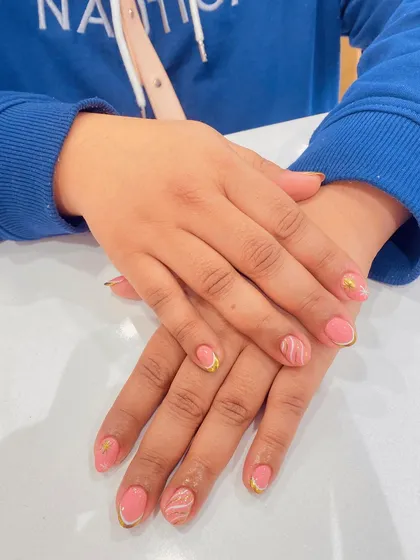 Here is another view of the delicate pink manicure with gold and white marble accents. It's a versatile design that is both professional for work and elegant for a special occasion.