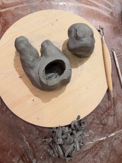 A look inside the sculpture. To ensure it fires properly without cracking, large clay pieces need to be hollowed out. This shows the hollow body and the head before they were joined.
