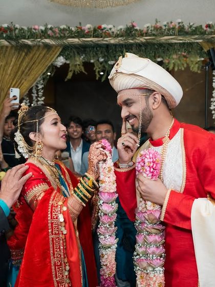 A playful moment between the Maharashtrian bride and groom after their wedding ceremony.