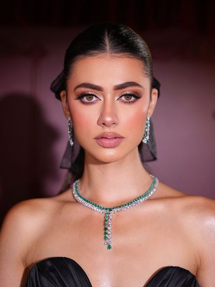 A close-up of the 'Coquette' look, showing the soft brown smokey eye and the flawless, luminous complexion.