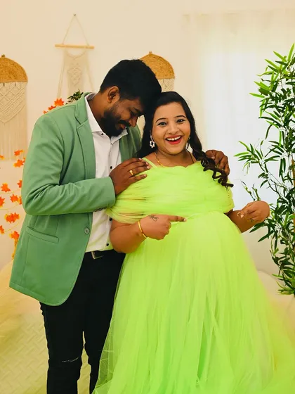 A playful and happy moment between a couple during their maternity shoot. The genuine smiles and laughter are what make a photo session truly special and memorable.