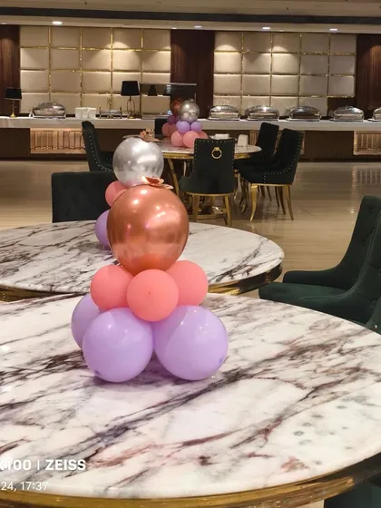 Simple balloon centerpieces on guest tables help carry the theme throughout the entire venue.