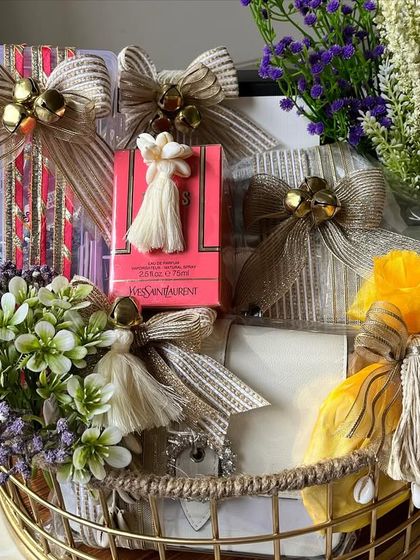 Gifts of love this Diwali. This metal basket is overflowing with beautifully wrapped presents and festive potlis, all brought together with a stunning dried floral arrangement.