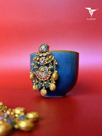 A celebration of craftsmanship and culture. These earrings feature intricate meenakari design, delicate pearls, and an opulent motif, with every gold detail designed to add a 'jhanak' to your style.