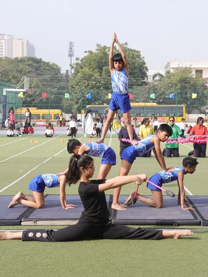 Students perform a complex gymnastics pyramid during our Annual Sports Day. Our gymnastics program focuses on building strength, flexibility, and coordination, allowing students to achieve remarkable feats of athleticism and teamwork.