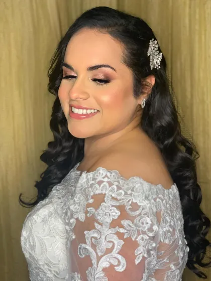 A side profile of Nimita, showing her elegant hairstyle and the flawless finish of her makeup.