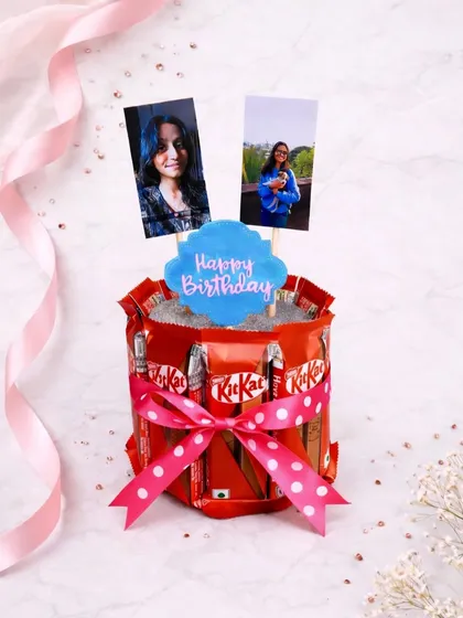 This is more than just a gift; it's a sweet memory. My custom chocolate 'cake' hamper is built with KitKats and topped with your favorite photos, making any birthday celebration truly unique.