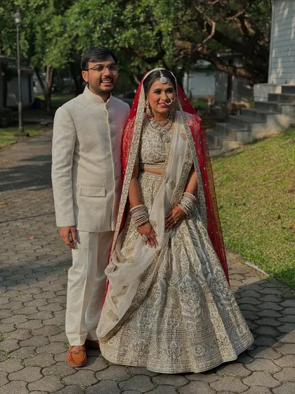 The happy couple. Her traditional yet elegant look is the perfect complement to his classic sherwani.