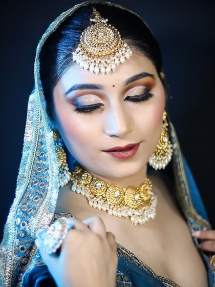 A serene pose of the bride, highlighting the beautiful cut-crease eye makeup.