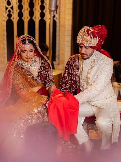 A candid from the wedding ceremony. Her makeup is traditional and elegant, matching the grandeur of the event.