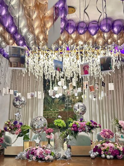 A view of the personalized photo gallery hanging from the balloon-filled ceiling. This unique decor idea makes the celebration deeply personal and memorable for the birthday girl and her guests.