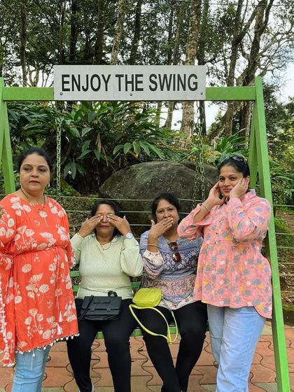 The three wise monkeys pose, but with a fun twist! A playful moment on a swing during our Wayanad trip.