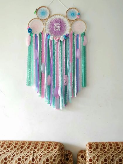 A pastel cluster dreamcatcher, perfect for welcoming a new little dreamer. This piece was created for a baby shower, featuring soft colors and a "Good Vibes" message.