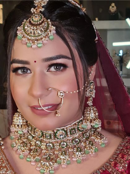 A close-up that captures the beautiful details of her makeup and jewelry.