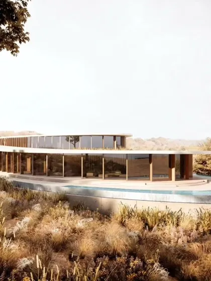 The sweeping curve of the villa's exterior, showcasing the use of natural materials and large glass panels to maximize views.