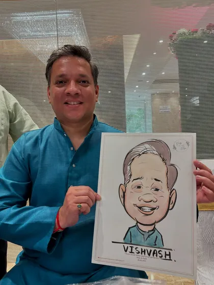 A guest in a blue kurta with his finished portrait. The simple color palette keeps the focus on the expressive face.