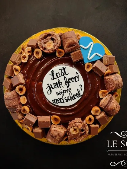 For when a regular cake just won't do, here is my giant doughnut cake. This 7-inch baked doughnut is loaded with a rich chocolate ganache, hazelnuts, and assorted chocolates, with a custom message for a fun celebration.