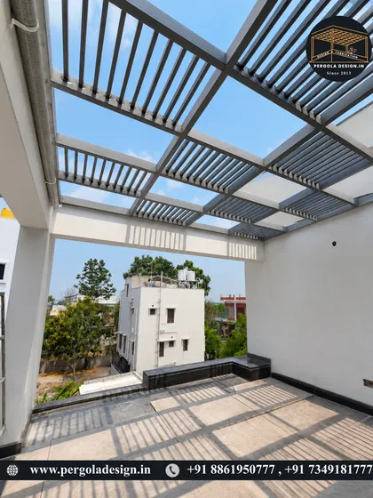 A view from within the pergola, looking out. The louvered design allows for an open, airy feeling and views of the sky, while the structure itself defines a comfortable and shaded living area on the terrace.