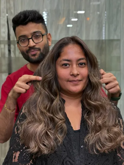 A perfect example of a cool-toned balayage. Here, I'm showing off the finished look on a client, with ashy blonde highlights woven through a darker base.