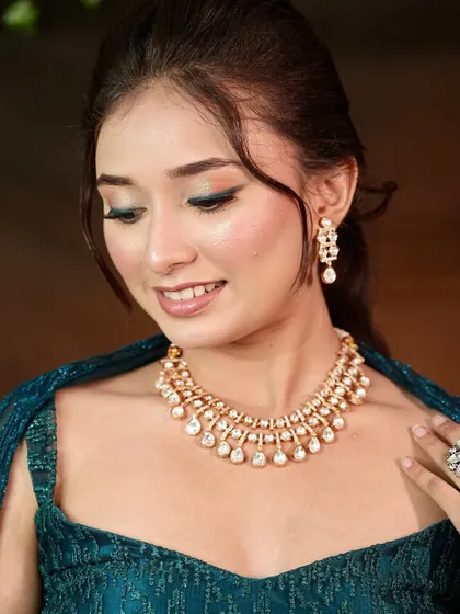 The complete look, showing how the Kundan necklace and matching earrings add a touch of grace to the modern outfit.